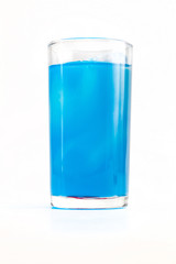 Full glass of butterfly pea flavored juice on white background