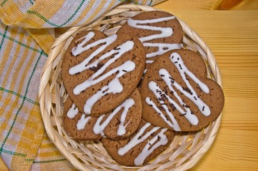 gingerbread hearts with chocolate sprinkles on a wooden table
