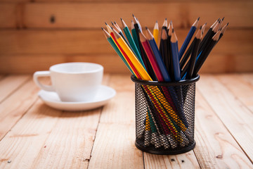 holder basket full of pencils with coffee cup