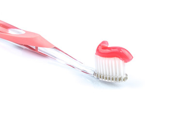 Toothbrush with pink toothpaste