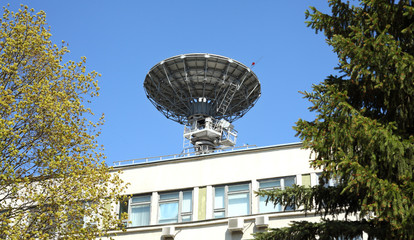 Satellite dish on the roof  on a background of blue sky