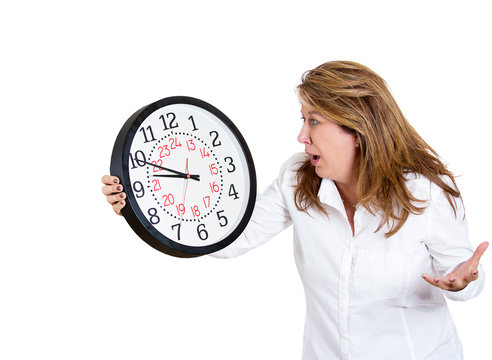 Running out of time.Stressed Businesswoman holding wall clock