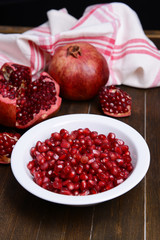 Ripe pomegranates on table close-up