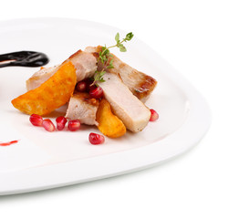 Grilled meat  with fried potato pieces and pomegranate seeds