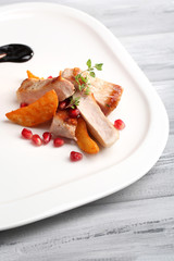 Grilled meat  with fried potato pieces and pomegranate seeds
