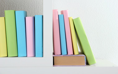 Fototapeta na wymiar Books on white shelves in room