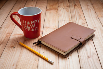 Coffee cup with notebook and pencil