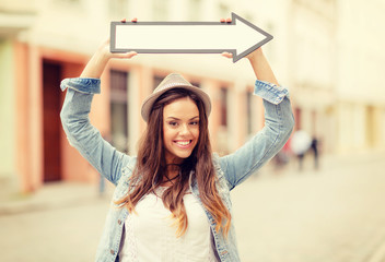 girl showing direction with arrow in the city