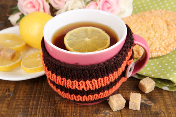 Cup of tea with lemon on wooden table