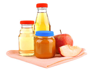 Baby food with apple in glass jars, isolated on white