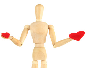 Wooden mannequin holding red hearts isolated on white
