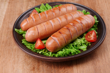 Grilled sausage on plate on table close-up