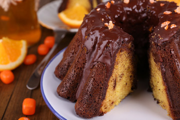 Tasty homemade pie with oranges on table close-up