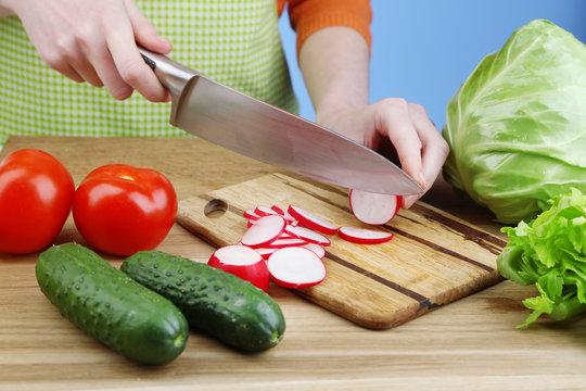 Female hands cutting celery