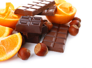 Chocolate, orange and  hazelnuts isolated on white