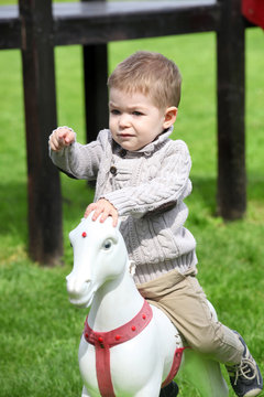 2 years old Baby boy playing with horse