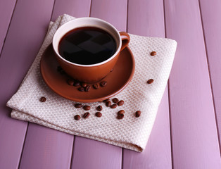 Cup of strong coffee on color wooden background