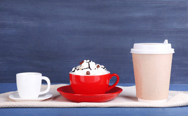 Assortment of coffee drinks on color wooden background