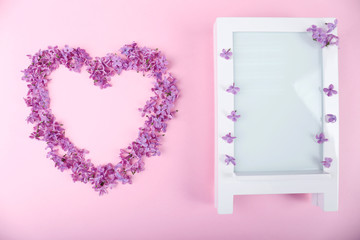 Beautiful lilac flowers in shape of heart and photoframe