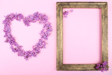 Beautiful lilac flowers in shape of heart and photoframe