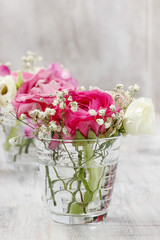 Tiny bouquets in glass vases. Wedding floral decorations