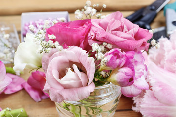 Florist workplace: incomplete tiny bouquets in glass vases. Step