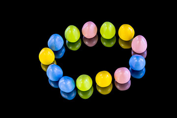 Colorful candy on a reflective surface