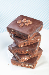 a pile of nutty milk chocolate coated brownies