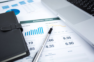 Businessman analyzing investment charts with laptop