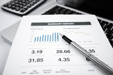 Businessman analyzing investment charts with laptop