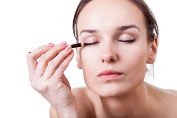 Woman using an eyeliner
