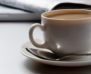 Cup of coffee near press.