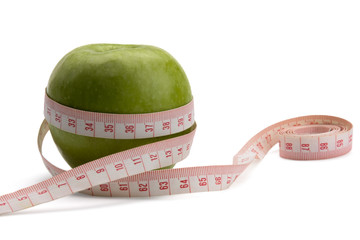 A green apple and a measurement tape