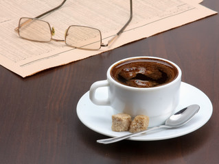 Cup of coffee and newspaper.