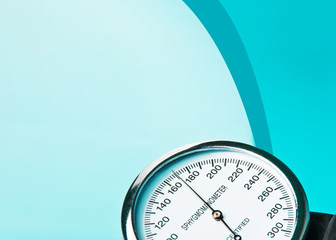 Sphygmomanometer on blue, reflective background