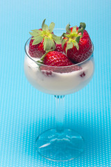 fresh strawberries on a glass with cream