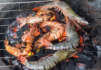 grilled shrimps  with flames in background 
