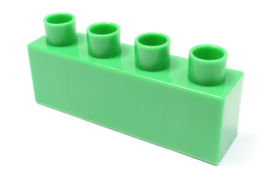 Green building block on white background