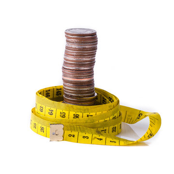 stack of coins with tape measuring isolated on white