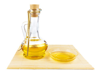 Glass bottle of oil and saucer with oil