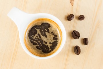 italian espresso coffee cup top view near beans