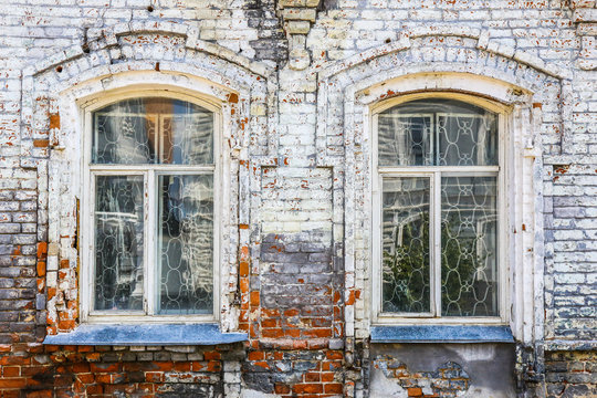 wall of old brick house with windows