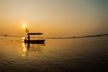 Fototapeta na wymiar Silhouette of a fisherman on the sunset.