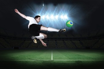 Fototapeta na wymiar Football player in white kicking