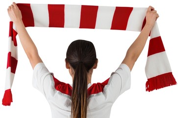 Football fan waving red and white scarf