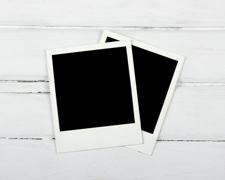 Polaroids on white plank