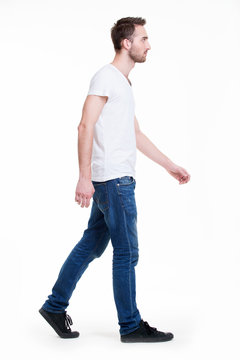 Full portrait of walking man in white t-shirt casuals.