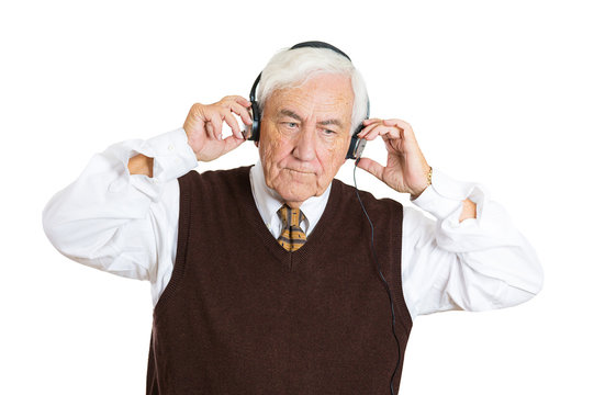 Senior elderly man listening to music with headphones