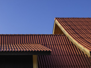 thai traditional roof tile against with blue sky