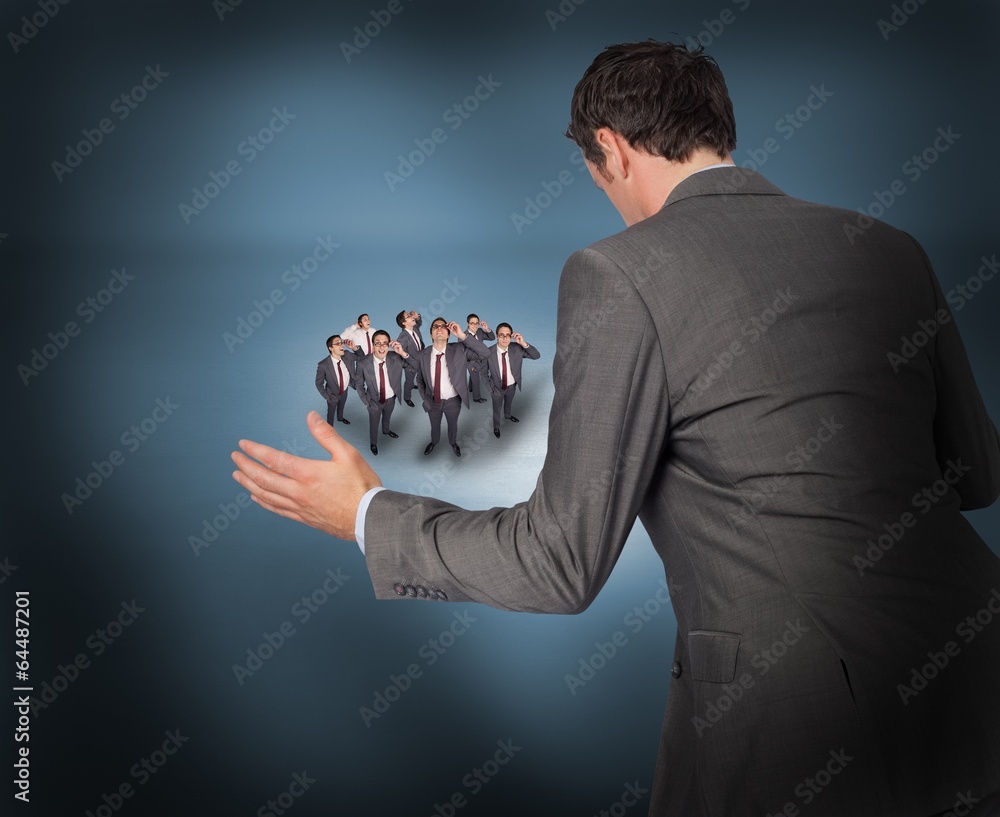 Poster Composite image of businessman posing with hands out with tiny b
